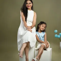 A stylish mother and daughter portrait. Their confident poses and coordinated outfits showcase their beautiful bond and individual personalities.