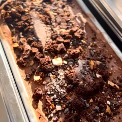 A close-up of a tray of our decadent Rocky Road gelato. The rich chocolate base is generously studded with nuts, marshmallows, and chocolate chunks, highlighting its handcrafted quality.