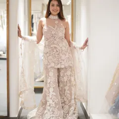 Who needs a crown when your outfit does all the talking? This all-white embroidered sharara set is the epitome of grace and elegance.