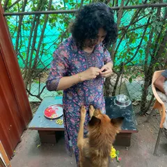 A dog eagerly reaches up for a treat after the puja. Celebrating together is a key part of our home-like atmosphere.