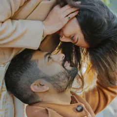 A playful and intimate top-down shot of a couple sharing a laugh. These creative angles help tell a more personal and unique pre-wedding love story.