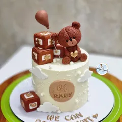 "We can bearly wait!" This adorable teddy bear cake is a favorite for baby showers. It features a hand-sculpted fondant bear, tiny blocks, and a sweet message for the parents-to-be.
