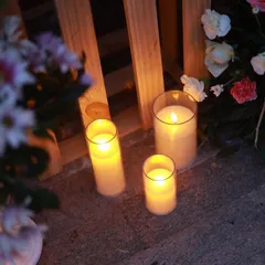 I use clusters of flameless candles in various sizes to create a safe yet magical ambiance. Here, they are placed alongside floral arrangements to light up the pathway for a romantic surprise.