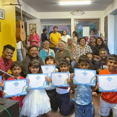 The graduating class of our Summer Camp, proudly holding their certificates with their parents and teachers.