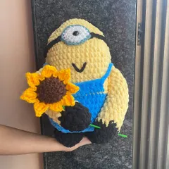 A custom order for a very soft and squishy Minion, holding a single crocheted sunflower. I used a plush, thick yarn for this to make it extra huggable.