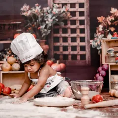 Getting hands-on with the dough during our kitchen-themed flour smash. I provide all the props, including the chef's hat and apron, for an authentic and fun experience.