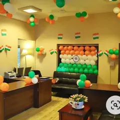 Here is a full office decoration I did for Independence Day. The main feature is a large backdrop of the Indian flag made entirely of saffron, white, and green balloons, complete with a printed Ashoka Chakra in the center. I also added smaller balloon clusters and flag bunting throughout the room.