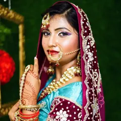 A beautiful Muslim bridal look. The focus is on the eyes, with a winged liner and purple eyeshadow, while the rest of the makeup is kept soft to balance the look under the dupatta.