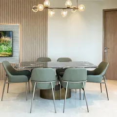 The dining area is where memories are made. For this space, we selected elegant seating for comfort and a modern chandelier that casts a warm, youthful glow, all set against a vertically paneled feature wall.