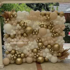 Our balloon walls are guaranteed to be the centerpiece of your party. This full-scale installation uses a soft, neutral palette of white, beige, and chrome gold for an elegant and modern birthday backdrop.