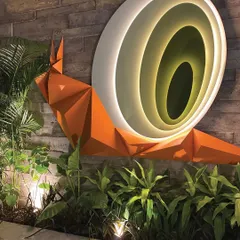 The snail art installation glows from within, its concentric circles drawing the eye. This piece is a perfect example of how I use art to create a unique and memorable landscape experience.