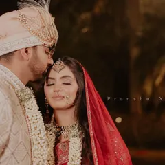 An intimate and heartfelt moment between the bride and groom on their wedding day. The groom's gentle kiss on her forehead is a perfect expression of love and care.