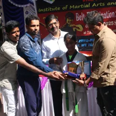 Hard work pays off. This is a proud moment for one of my students as she is awarded her new belt and a trophy during our official belt examination ceremony. Every belt is earned through dedication.