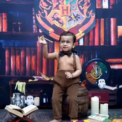 A little wizard practicing his spells. This Harry Potter setup in my Vashi studio comes complete with a magical library backdrop and enchanted props.