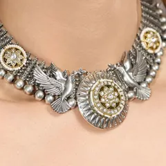 A closer view of the dove motifs and intricate silverwork on our Mystic Wings choker.
