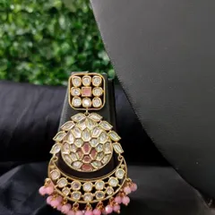 A beautiful chaand bali style earring with pink beads and kundan work.