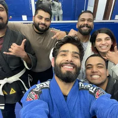 A close-up selfie with some of our members, showcasing the detailed patches and belts of the BJJ Gi.