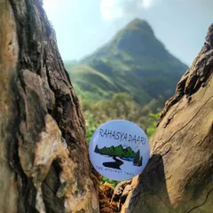 A creative shot of my badge nestled in a tree, with the Ettina Bhuja peak in the background. It represents my commitment to finding unique perspectives on popular trails.