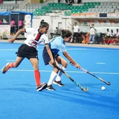 Intense one on one action during the Khelo India Women's Hockey League. My players are trained to be aggressive on the ball and relentless in their pursuit of victory, seen here in a tough tackle.