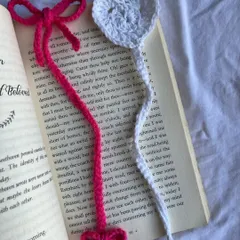 A closer look at my bow and heart bookmark designs. These are handmade with soft yarn and are thin enough to sit comfortably between the pages of your favorite book without damaging the spine.