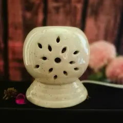 My new Electric Wax Melt Warmer, unlit. Its ceramic design with floral cutouts is beautiful enough to be a decor piece on its own.