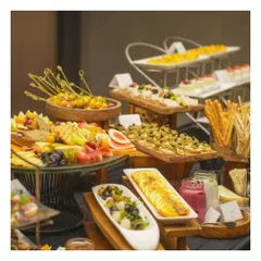 Another perspective of our stunning grazing table, showcasing the variety from fresh fruit skewers to savoury bruschetta and cheese boards. We use different heights and textures to create a visually dynamic and inviting spread.