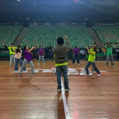 A shot from the final rehearsals on the main court at Tyagaraj Stadium. I'm guiding my dancers through the blocking and spacing to ensure the performance looks perfect from every angle in the massive venue.