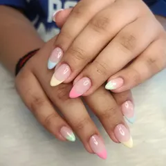 Can't decide on one color? Try them all! These pastel rainbow French tips on almond-shaped extensions are a fun and playful way to add a pop of color to your look.