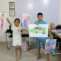 Look at these proud smiles from our Saturday junior batch! Students are showing off their unique creations, including a cool green sports car and a beautifully drawn character.