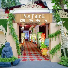 Welcome to the jungle! For this safari-themed event, I created a lush entrance with faux greenery, animal silhouettes, and life-sized giraffe and gorilla statues to transport guests to a wild adventure.
