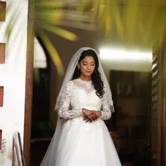 A full-length portrait of the bride in her stunning white lace gown. I styled her hair in soft curls and kept her makeup classic and timeless to match the elegance of her dress.