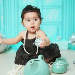 A playful moment during the 'Tiffany & Co.' themed shoot, with disco balls and a tea set adding to the fun.