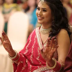 A candid moment of joy during the sangeet. Our long-lasting makeup ensures that our bride looks fresh and radiant even while enjoying the festivities.