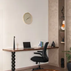 This home office nook is seamlessly integrated into the living area. The desk features a unique, sculptural leg, demonstrating how we can blend work and living spaces with artistic flair.
