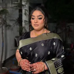 A classic party look featuring a black saree. We created a bold, winged eyeliner and a soft, messy updo to give it a modern and sophisticated feel.