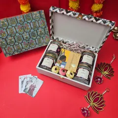 This elegant Diwali hamper features a stunning floral-patterned trunk box. Inside, we've curated a selection of premium dry fruits, chocolates, and playing cards for the festive season.
