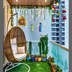 A classic swing chair is a perfect addition to any balcony for instant relaxation. In this design, I paired a comfortable wicker egg swing with soft artificial grass underfoot and a backdrop of twinkling fairy lights, creating a whimsical and cozy nook with a view of the city.