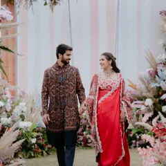 A walk to remember. The floral archway, filled with pampas grass and pastel blooms, created a dreamy entrance for the happy couple at their Mehendi.