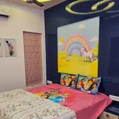 This child's room features a magical unicorn and rainbow mural above the bed. The bright, happy colors create a cheerful atmosphere perfect for a young dreamer.