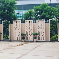 A wider view of the same project shows how the alternating pattern of green walls and decorative panels creates a dynamic and modern aesthetic. This is an effective way to enhance the landscape design of corporate campuses or public plazas.