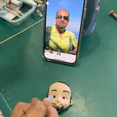 A behind-the-scenes look at how we create our personalized figurines. Here, we are matching the facial features from a photo to create a realistic and handcrafted edible caricature.