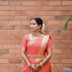 A full view of Ruchira's timeless muhurtha look. My focus was on creating a flawless base that looked like real skin, paired with classic eye makeup that enhanced her features without overpowering them.