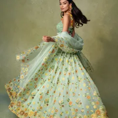 An action shot for a lookbook, capturing the beautiful flare of a floral lehenga. Showing movement is a great way to demonstrate the fabric's weight and flow to online shoppers.