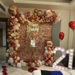 This rose gold sequin backdrop creates a warm, sparkling ambiance for any celebration. Framed by a white and rose gold chrome balloon arch with butterfly details, it’s an elegant choice for a milestone anniversary party.