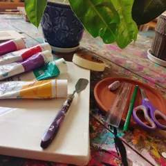 A blank canvas and a fresh set of supplies, ready for a new project to begin. We provide everything you need to explore different mediums of art with us.