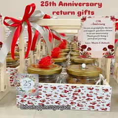 A close-up of a silver jubilee return gift basket, showing the custom '25 Years' tag and the floral-patterned design.