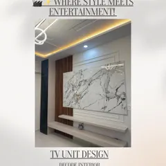 Where style meets entertainment. This TV unit design is a focal point, featuring a large marble panel, vertical wooden fluting, and a minimalist floating shelf, all highlighted by integrated backlighting.