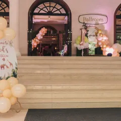 The entrance to the "Wild One" party, with a custom welcome sign and balloon arrangements leading guests into the ballroom, which I transformed into a jungle.
