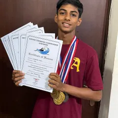 Aryaman Suri proudly displays his collection of medals and certificates of honor from the District Swimming Championship. Each one represents a milestone in his development as a competitive swimmer, reflecting his hard work and the success of our program.