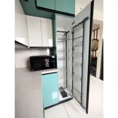 This tall pantry unit provides immense storage capacity. The pull-out wire baskets allow for easy organization and access to all your groceries, making it a highly functional feature in any modern kitchen.